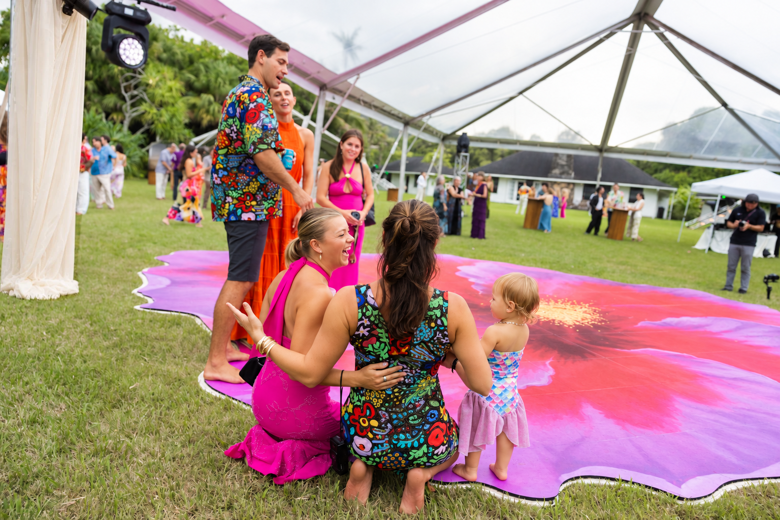 Guests and a young child gathering at the edge of the hibiscus dance floor